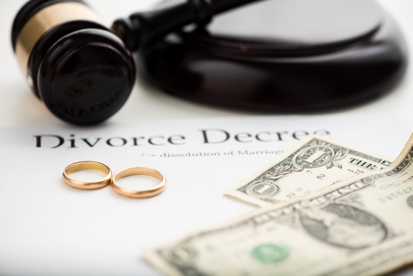 divorce decree, money, and wedding rings