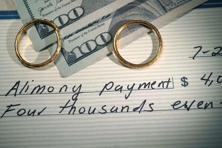 Wedding Rings on alimony check and cash