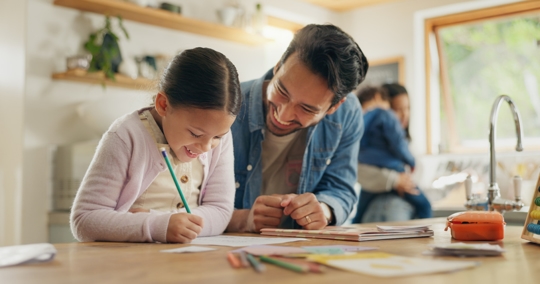 father helping daughter with homework