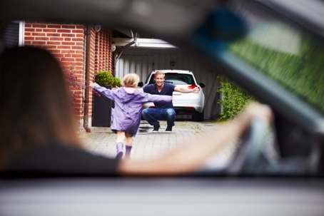child running to father while mother watches
