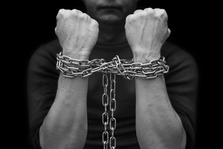 Male hands with chain wrapped around them, prisoner concept. Hostage concept