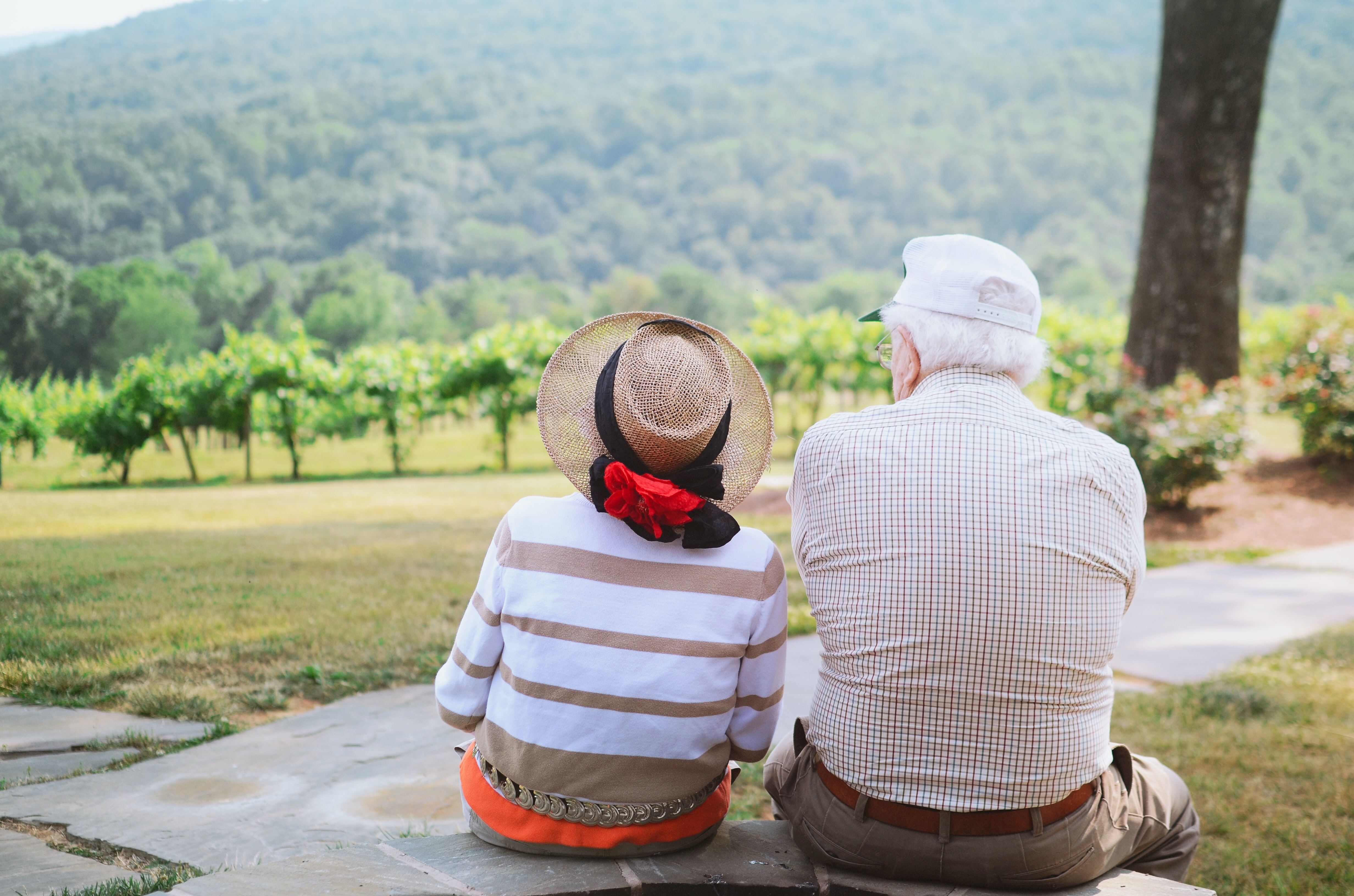 elderly couple sitting outside