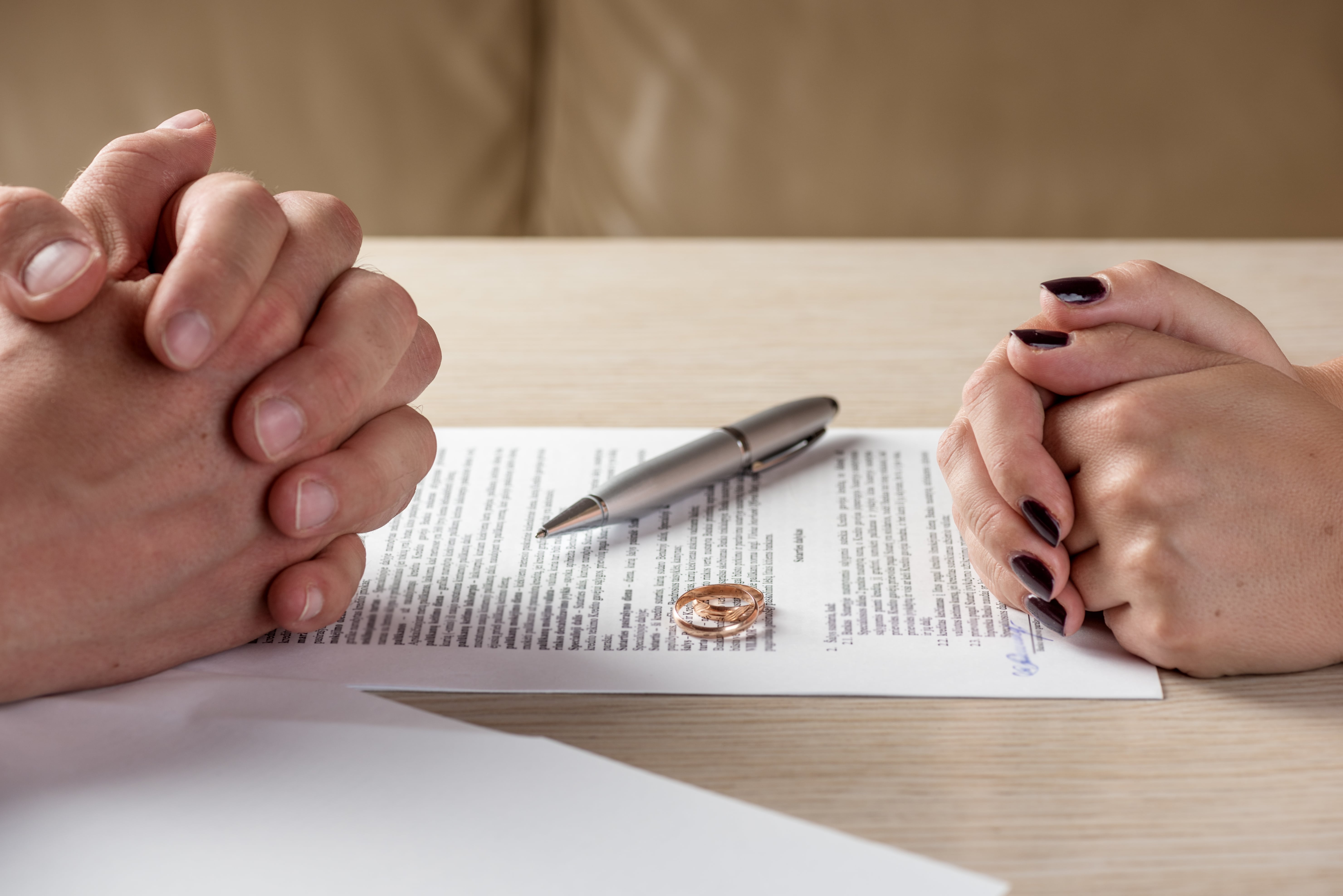 rings sitting on a divorce decree document